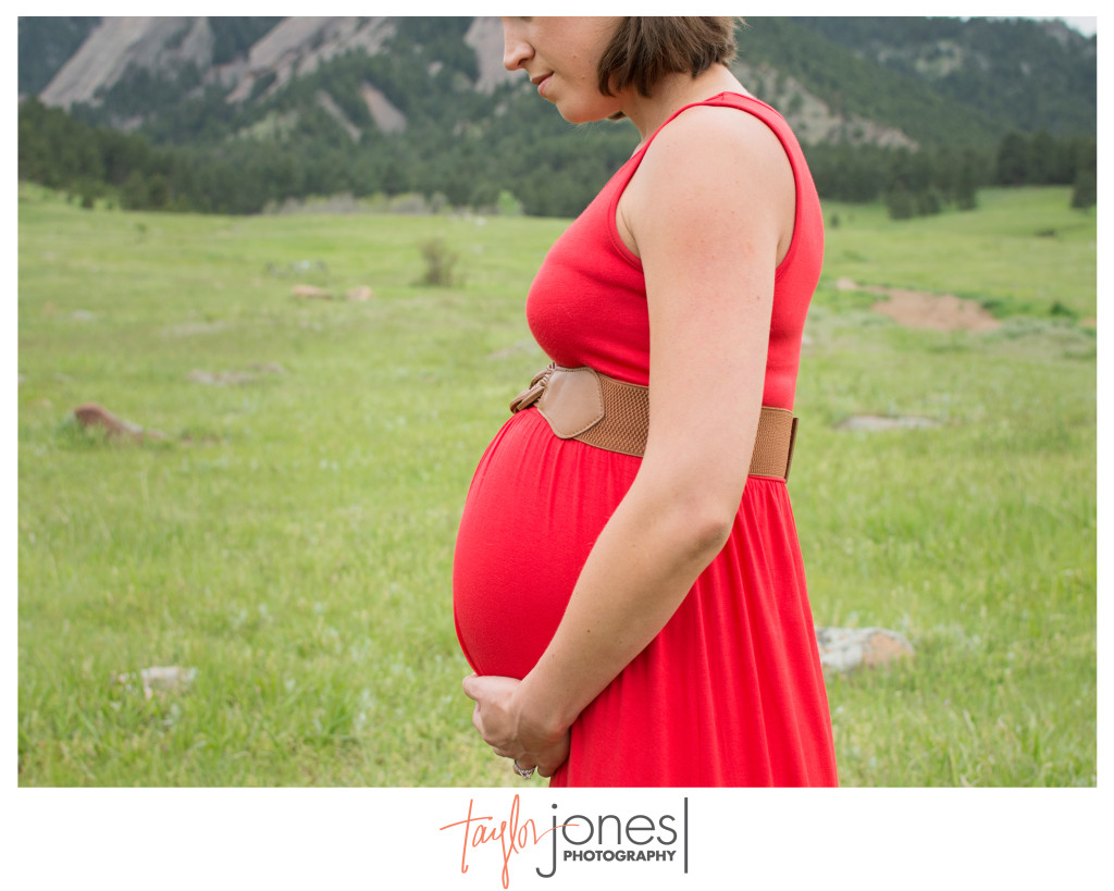 Profile of soon to be mother in a red dress at her maternity shoot in Boulder, Colorado