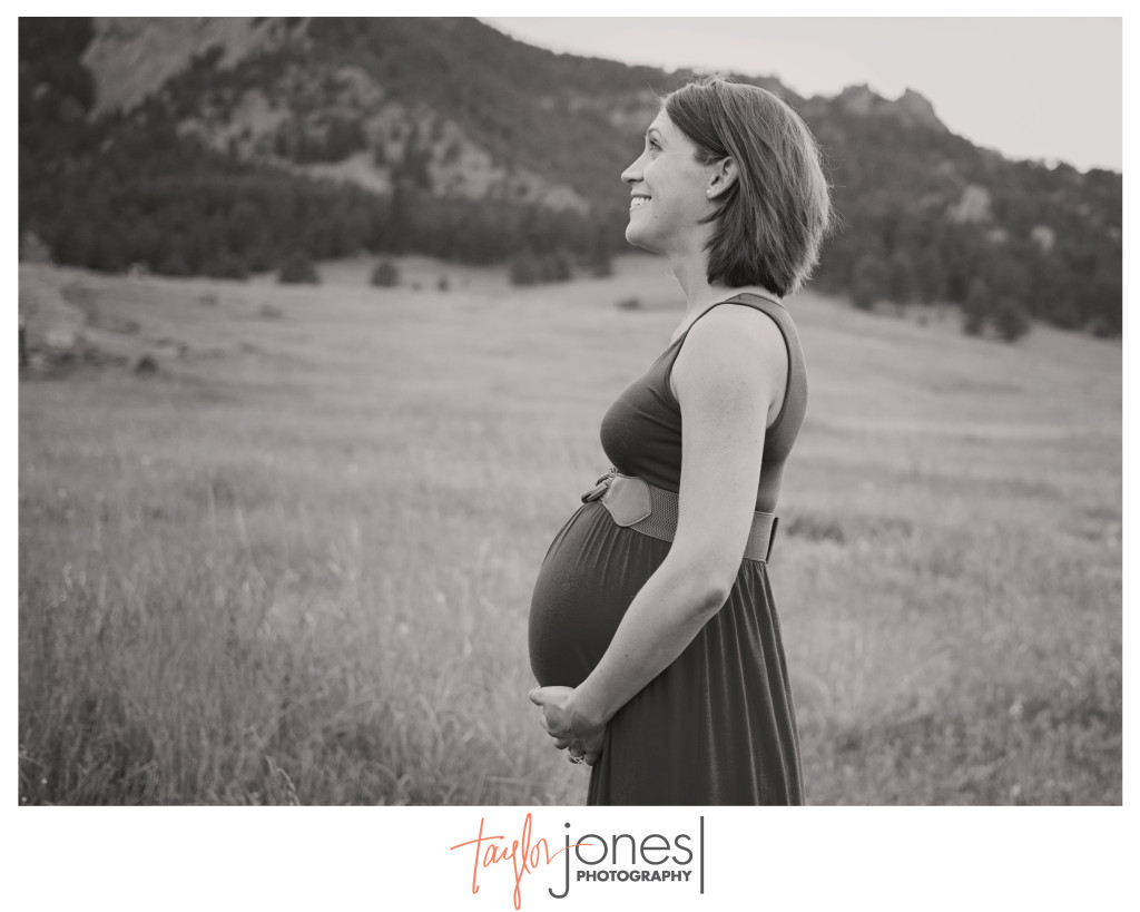 Soon to be mother standing at Chautauqua Park in Boulder, Colorado. Photography in a field at sunset maternity shoot. 