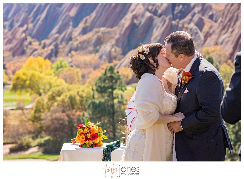 First kiss at Arrowhead Golf Course wedding ceremony in the fall
