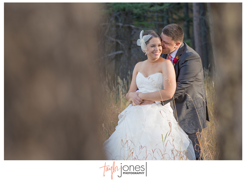 Bride and groom in trees at Pines at Genesee wedding