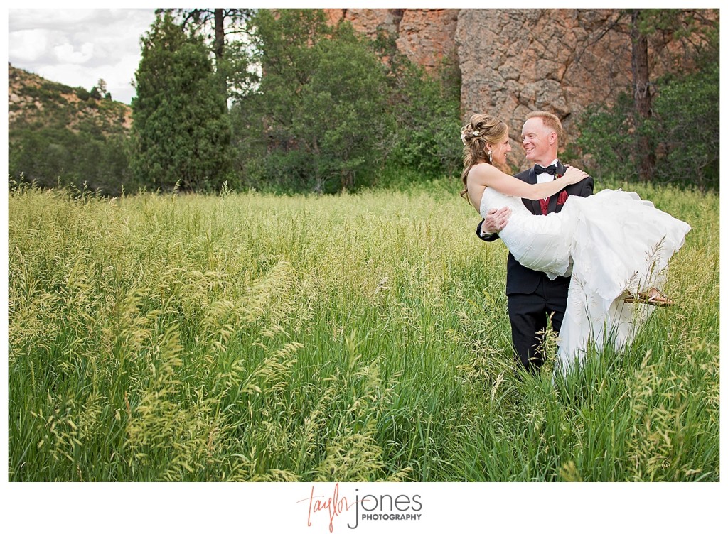 Bride and groom portraits at Perry Park wedding in field with red rocks