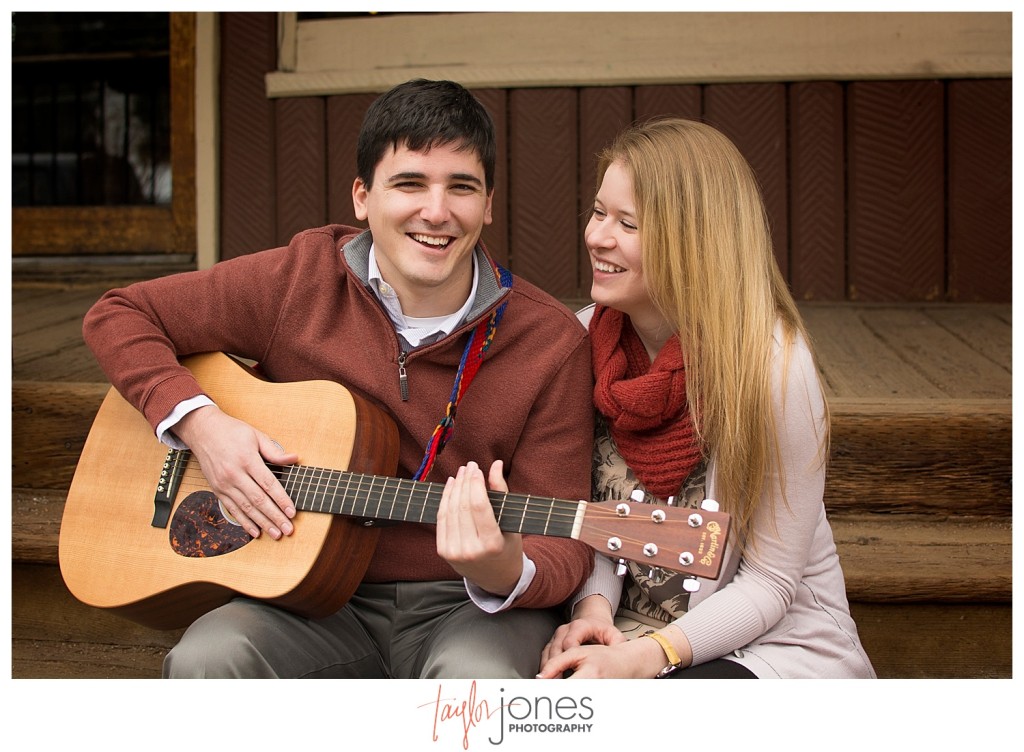 Couple playing guitar at Engagement shoot in downtown Evergreen