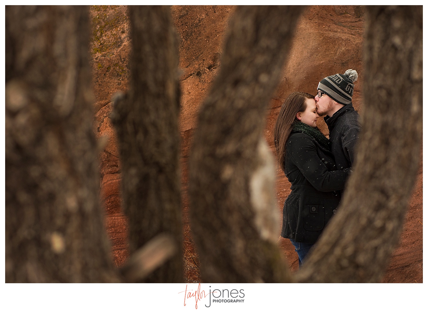Through the trees at Red Rocks engagement shoot