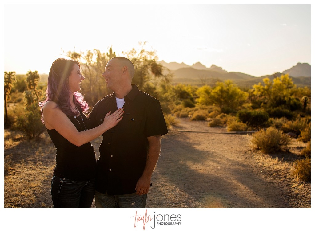 Couple at Arizona engagement shoot at sunset laughing