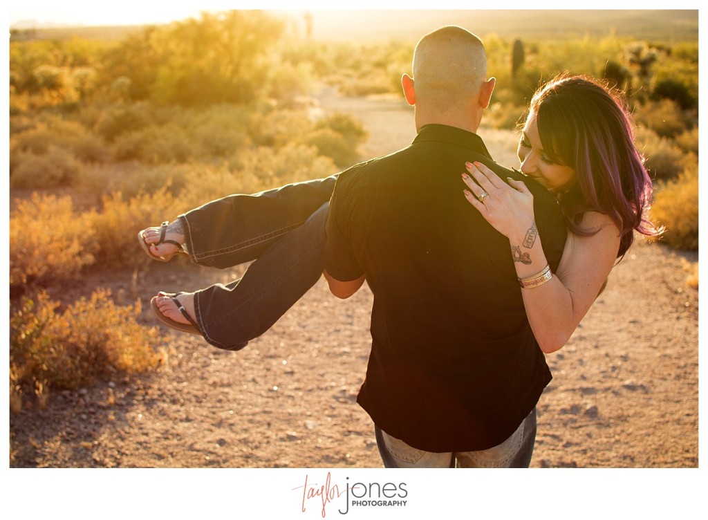 Groom carrying bride at Lost dutchman state park