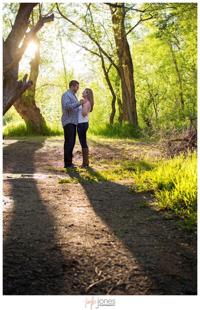 Colorado engagement shoot at Lair O the Bear couple dancing in sunlight and trees