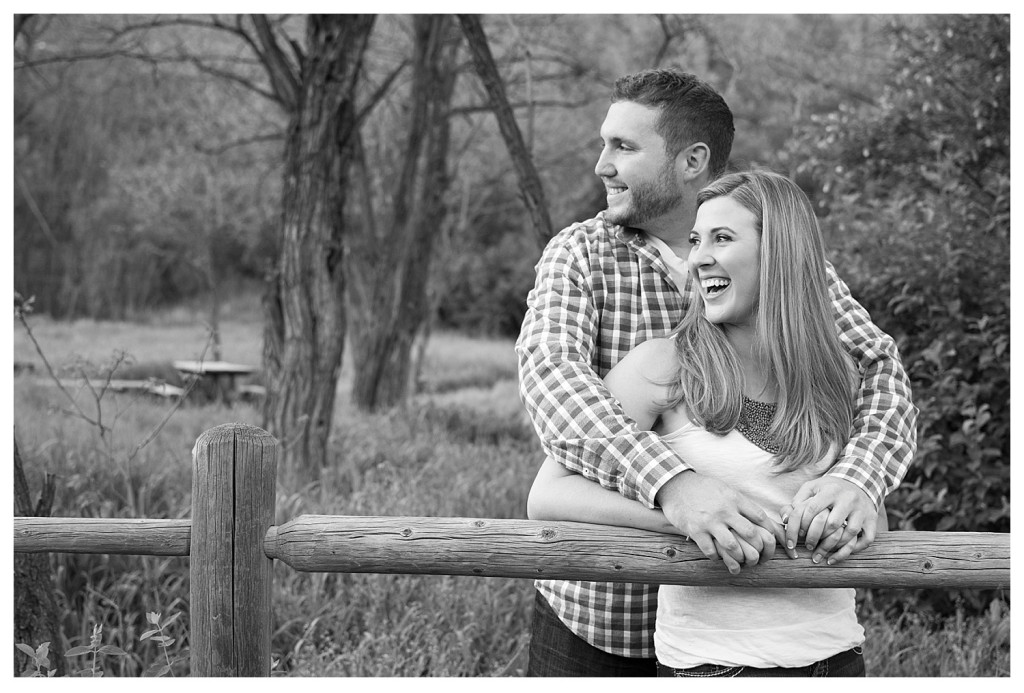 Colorado engagement shoot at Lair O the Bear couple kissing on a fence