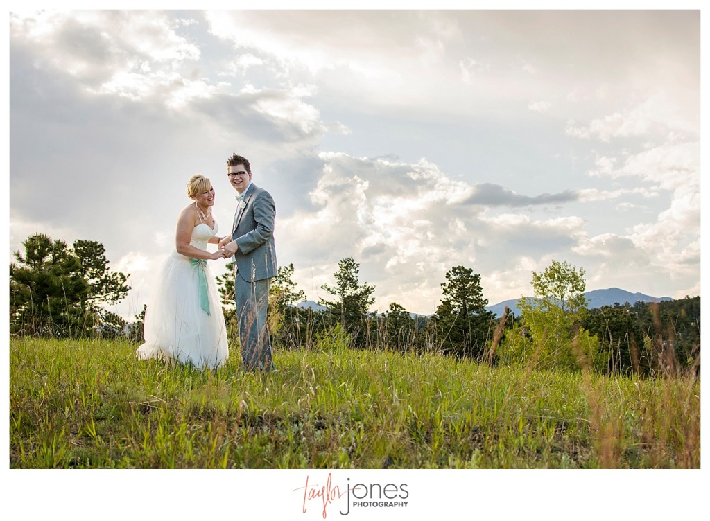 Bride and groom portraits dancing at Pines at Genesee wedding with mountains