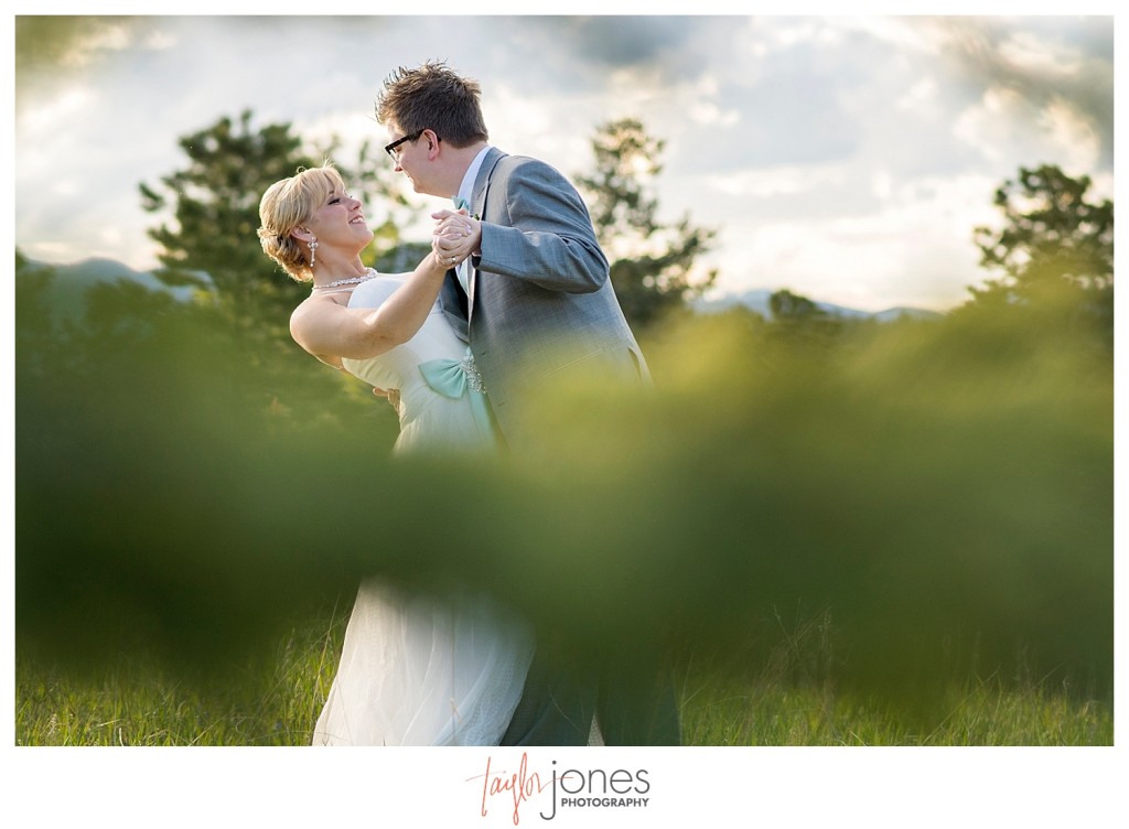 Bride and groom portraits dancing at Pines at Genesee wedding with mountains