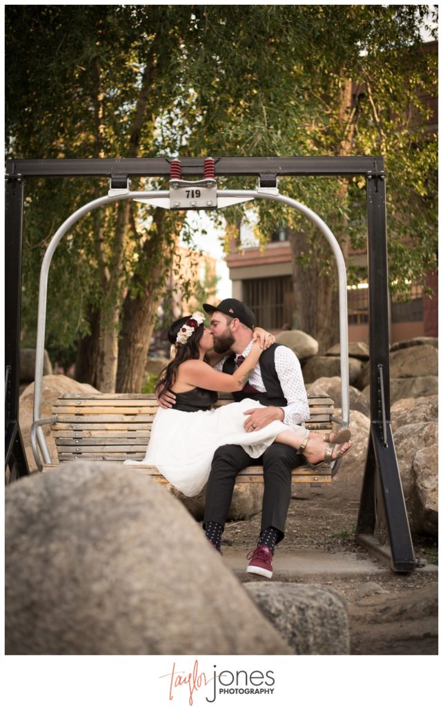 Couple at Salida SteamPlant wedding in ski lift chair