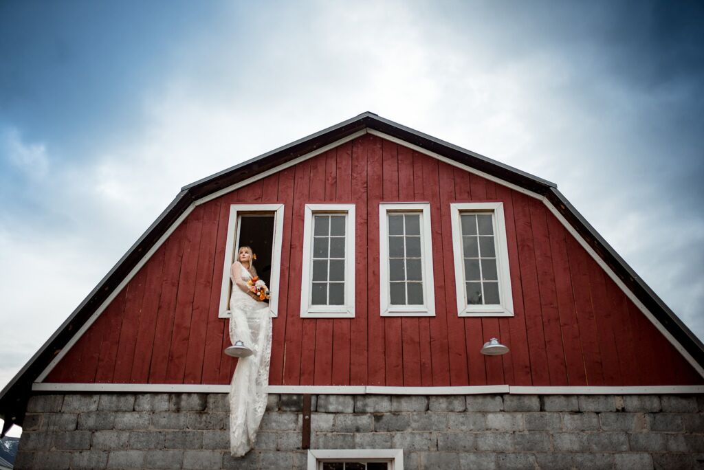 The Barn at Howard Creek Farm wedding in Howard Colorado bride in window